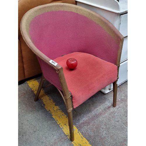346 - A vibrant tub chair with padded seat. In a pink and gilt finish.