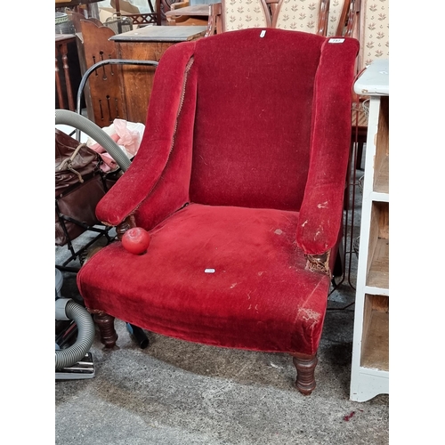 757 - A victorian  century nursing chair with plush red upholstery and castors to back legs. Nice shape to... 