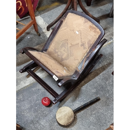 760 - An Edwardian Regency style rocking footstool, along with tribal African rattle drum.