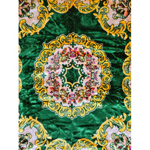 765 - A very colourful large velvet throw with a green ground background and a yellow plain lined back. Co... 