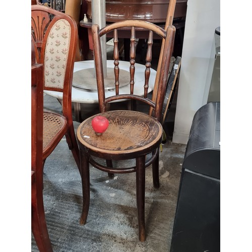 774 - A wonderful 1930s bentwood bistro chair with turned backrest supports and foliate design to seat.