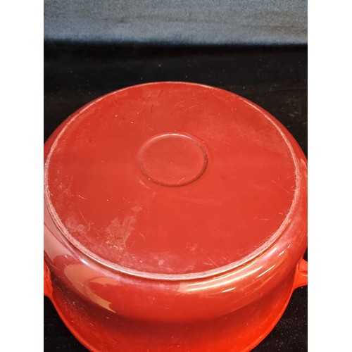 130 - A large Le Creuset cast iron pot with lid. In a red finish.