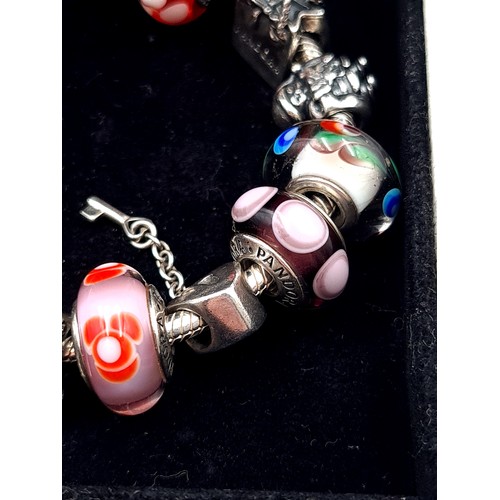 814 - A beautiful original Pandora Charm Bracelet, set with 10 charms, weight 54.53gms, contained in origi... 