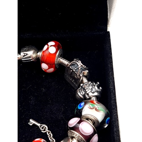 814 - A beautiful original Pandora Charm Bracelet, set with 10 charms, weight 54.53gms, contained in origi... 