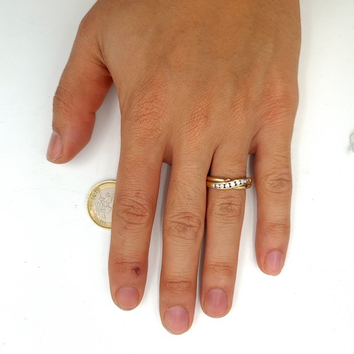 28 - A 9ct Gold twist set mount set with a channel cupped gem stone setting. Ring size O, weight 1.95gms.... 