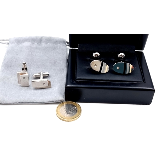 986 - Two pairs of stylish sterling silver gentleman's cufflinks including a boxed example.