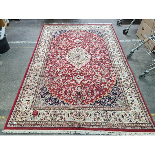 932 - Star Lot : A stunning large hand knotted Persian style woolen rug featuring a beautiful ornate geome... 