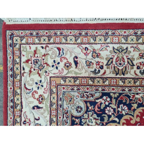 932 - Star Lot : A stunning large hand knotted Persian style woolen rug featuring a beautiful ornate geome... 