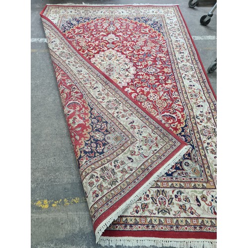 932 - Star Lot : A stunning large hand knotted Persian style woolen rug featuring a beautiful ornate geome... 