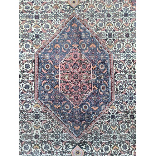 933 - An exquisite hand knotted Persian style woolen rug featuring a rich tapestry of an intricately Star ... 