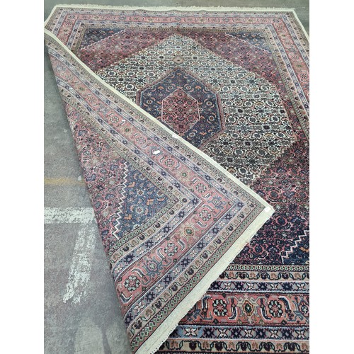 933 - An exquisite hand knotted Persian style woolen rug featuring a rich tapestry of an intricately Star ... 