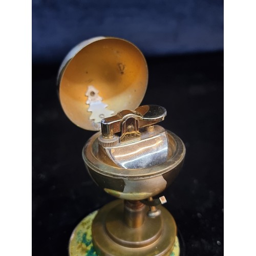 123 - Two stylish desktop items both in the form of globes including a music box lighter (smaller) and a c... 