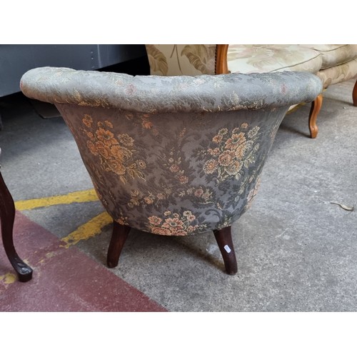 257 - A captivating Victorian tufted tub armchair, featuring floral upholstery, button back and ornate woo... 