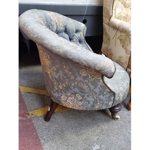 257 - A captivating Victorian tufted tub armchair, featuring floral upholstery, button back and ornate woo... 