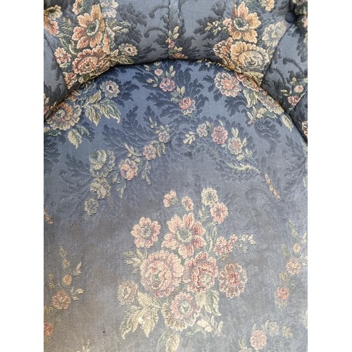 257 - A captivating Victorian tufted tub armchair, featuring floral upholstery, button back and ornate woo... 