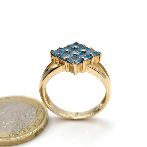 23 - Star Lot : Exquisite 9k gold ring, featuring nine radiant-cut aquamarine gems, masterfully crafted o... 