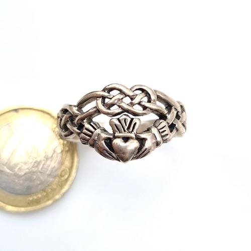 429 - A very good heavy example of a sterling silver Vintage Claddagh Ring with celtic design mount. Ring ... 