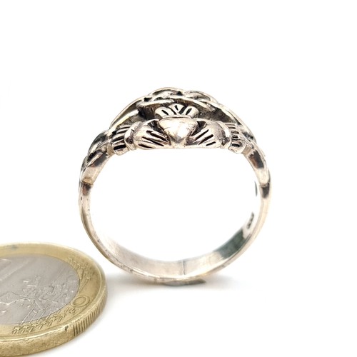 429 - A very good heavy example of a sterling silver Vintage Claddagh Ring with celtic design mount. Ring ... 