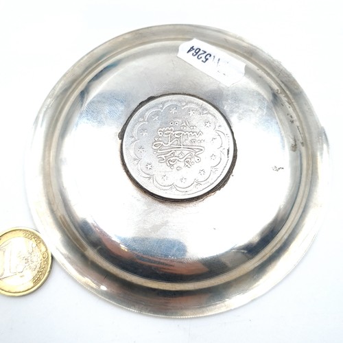 474 - An Indian silver Pin Dish set with coin base. Dims - 11cm diameter, weight 65.63gms.