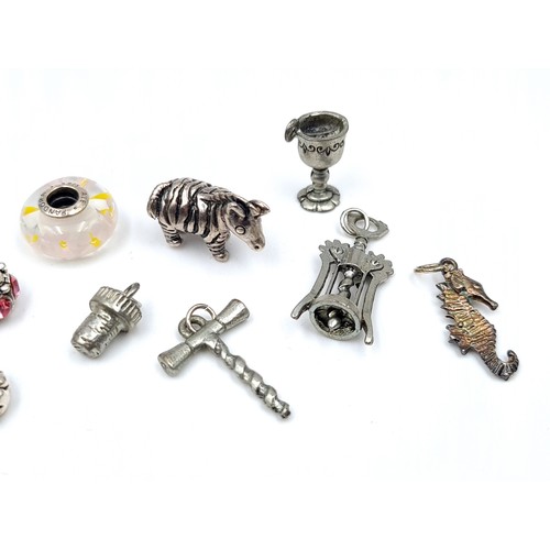 482 - An assorted collection of Charms, including lots of  Sterling silver examples, weight 32.45gms