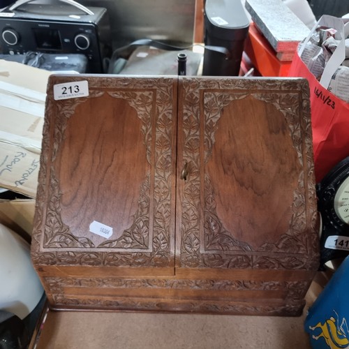 213 - A wonderful oak stationery cabinet with intricate carved detailing and brass fittings. With multiple... 