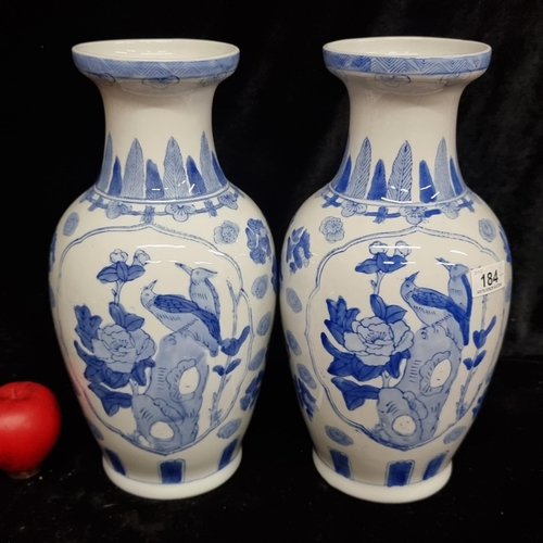 184 - A pair of large  pretty Chinese vases in the traditional blue and white colour pattern depicting son... 