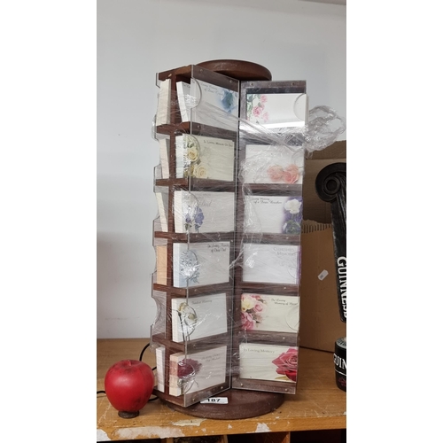 187 - A counter top wooden shop display stand with swivel base., Full of Cards.