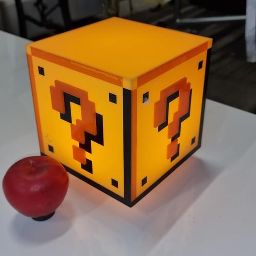 671 - A super cool Mario night light in the form of a mystery block. Press down to turn on. Plays the infa... 