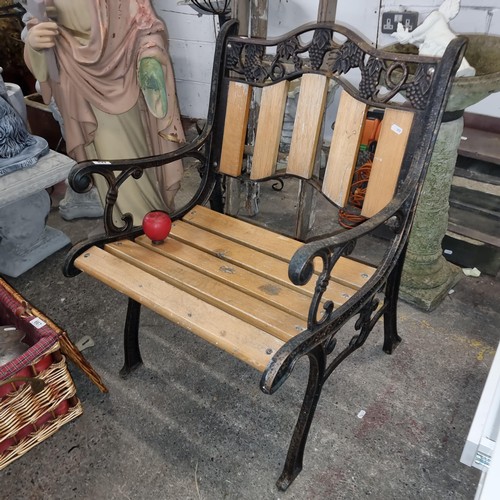 668 - A charming very heavy cast iron garden seat with lovely grape and vine motif to back. In very good c... 