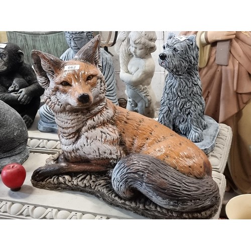 662 - A fabulous and very heavy reconstituted stone garden sculpture of a cunning fox, with bushy tail and... 