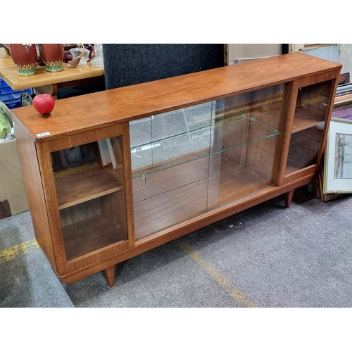 843 - Star Lot : A sumptuous mid century modern teak glass fronted sideboard with sliding and pull glass d... 