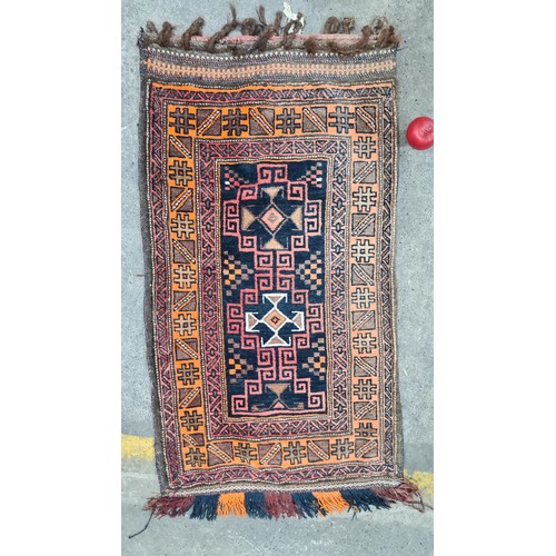 946 - Star Lot : An unusual hand knotted woolen rug with fabulous geometric pattern to front. Features sli... 