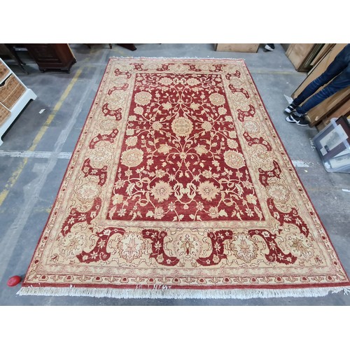 951 - Star Lot : An incredibly very large hand knotted woolen rug featuring a delicate foliate pattern in ... 