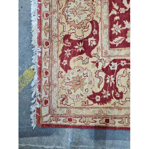 951 - Star Lot : An incredibly very large hand knotted woolen rug featuring a delicate foliate pattern in ... 