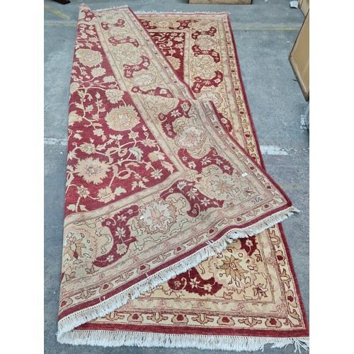 951 - Star Lot : An incredibly very large hand knotted woolen rug featuring a delicate foliate pattern in ... 