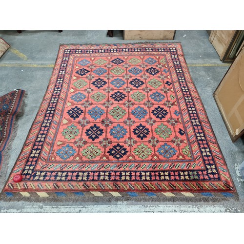 949 - Star Lot : An eyecatching hand knotted woolen rug featuring a bright floral pattern in a diverse col... 