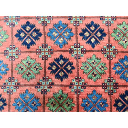 949 - Star Lot : An eyecatching hand knotted woolen rug featuring a bright floral pattern in a diverse col... 