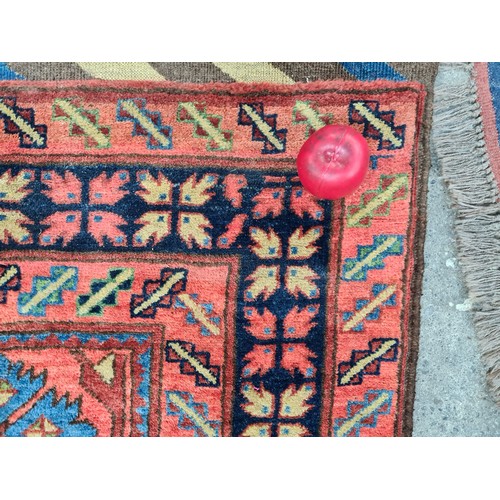 949 - Star Lot : An eyecatching hand knotted woolen rug featuring a bright floral pattern in a diverse col... 