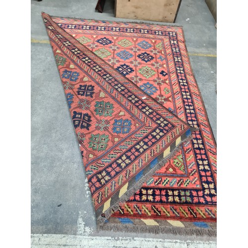 949 - Star Lot : An eyecatching hand knotted woolen rug featuring a bright floral pattern in a diverse col... 