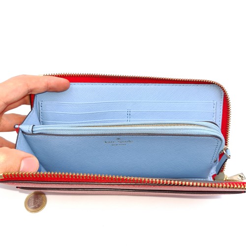 11 - An as new Kate Spade New York Spade purse set in red leather with powder blue lining. Dimensions 21c... 