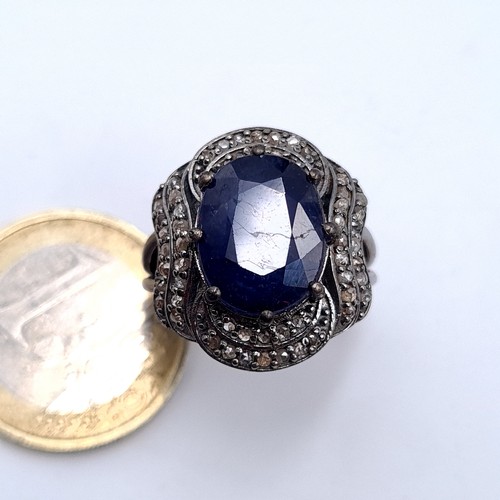 50 - Star Lot : A most attractive large sapphire 6.4 Cts facet cut stone with diamond surround set in ste... 