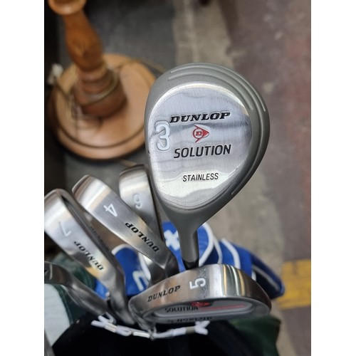 396 - A collection of 11 Dunlop Solution golf clubs including 5 and 3 woods, a driver, S and P wedges and ... 