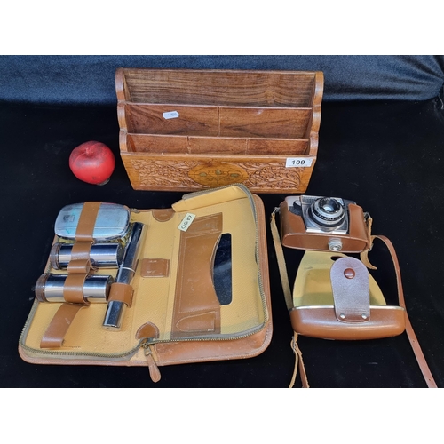 109 - Three vintage items including a gentleman's travel kit, an ornately carved letter rack and Agfa came... 