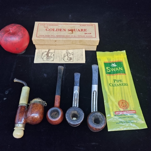 110 - A collection of four vintage pipes including a golden square and an unusual German example with box ... 