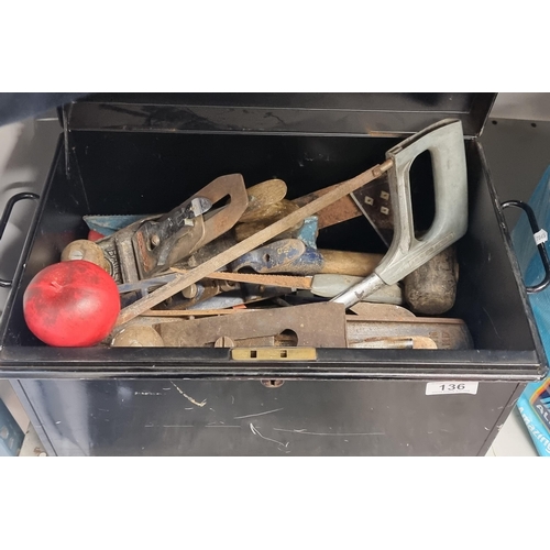 A large metal antique deed box from Veteran Series containing approx. 20 tools including wood planes, a hand saw and a hammer.