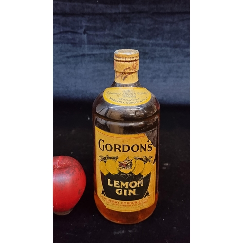 144 - Star Lot: A rare sealed 1950s bottle of Gordon's Lemon Gin. Most likely 75cl, not legible from label... 