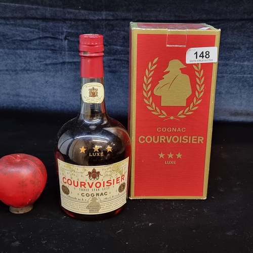 148 - Star Lot: A sealed 1970s bottle of Courvoisier Three Star Luxe Cognac. Most likely 75cl. Comes with ... 