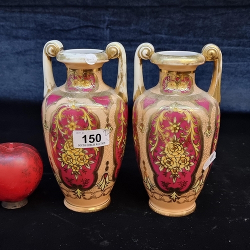 150 - A lovely pair of Japanese Noritake urn vases boasting a gilt and pink floral design in vignettes. In... 