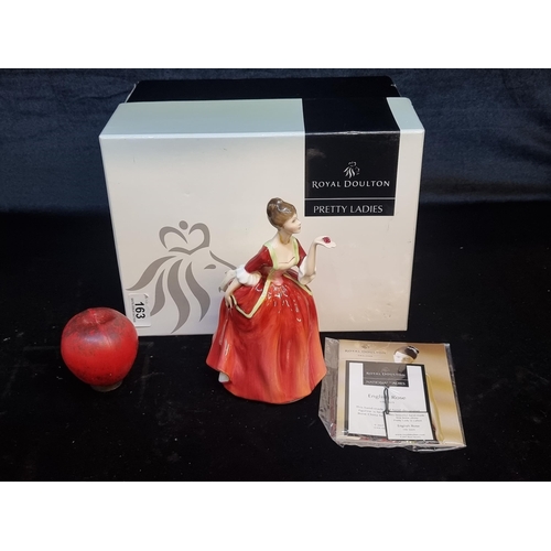 163 - A Royal Doulton hand made porcelain figure of a lady in a red dress titled 'Flower of Love'. Comes w... 