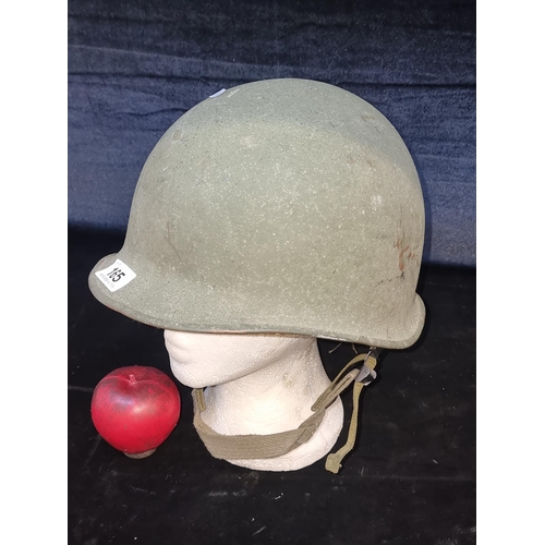 165 - A World War 2 M1 U.S. military helmet with inner liner and straps.